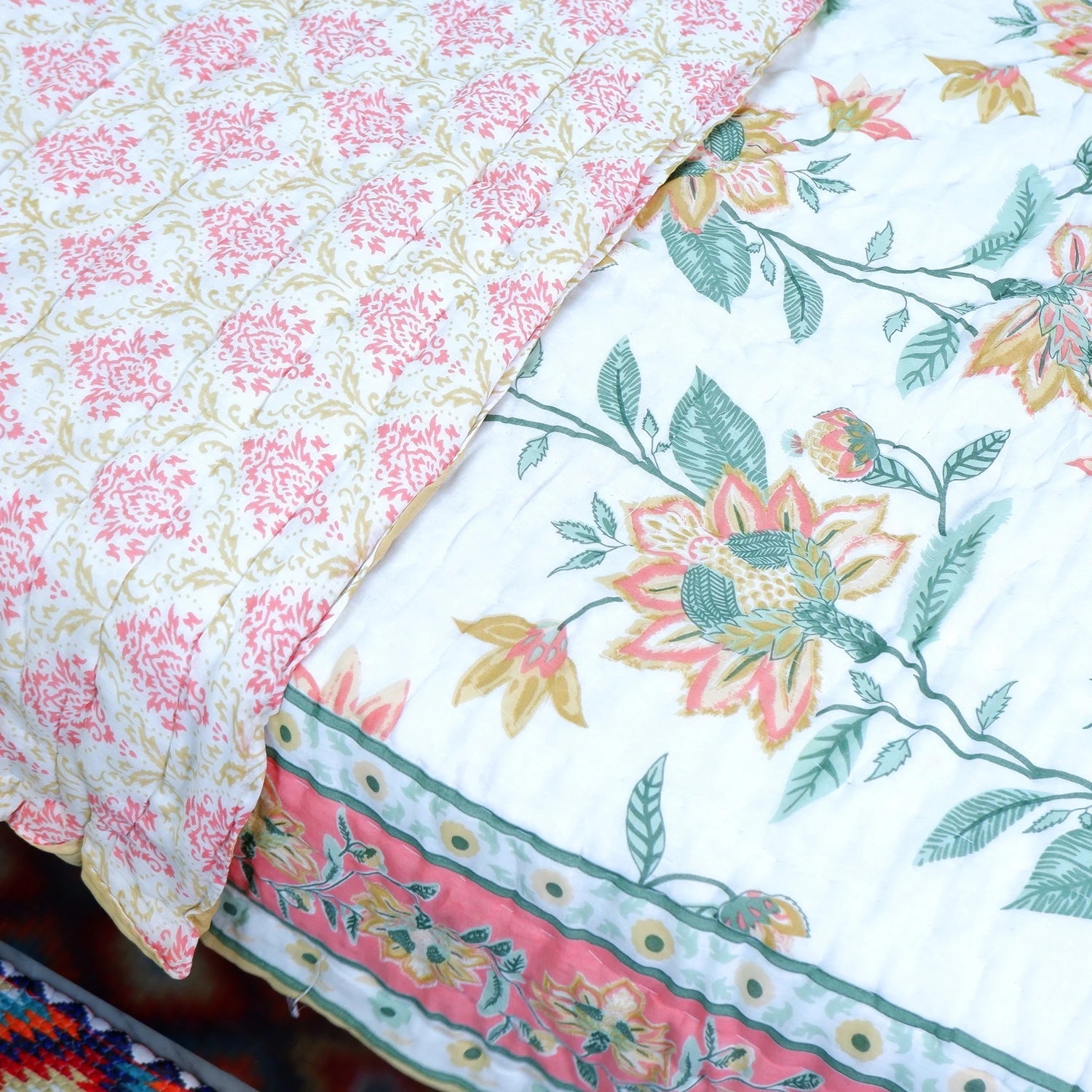 Jaipuri cotton quilt double bed with intricate floral patterns in vibrant colors on a cozy bedding set